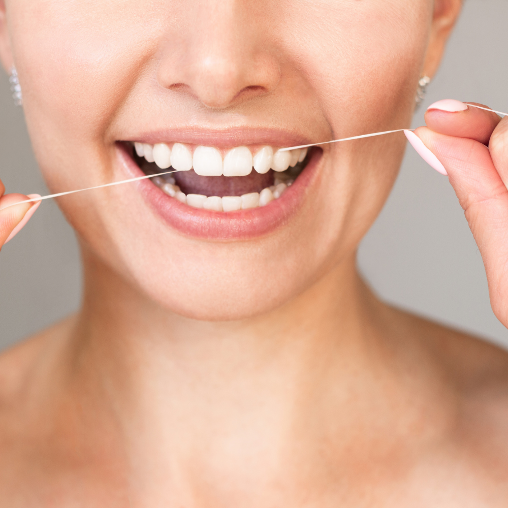 woman flossing her teeth